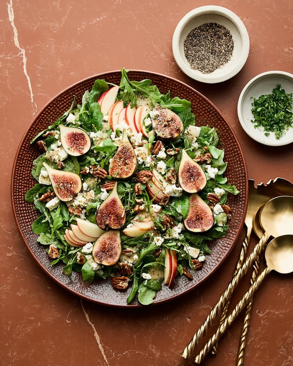 A large round brown plate filled with a fresh salad, starting with a base of dark green spinach and arugula leaves that create a leafy texture filling the plate. On top, there are many slices of light pink figs with visible seeds, creamy white crumbles of cheese scattered evenly, thin red and white apple slices, and some glossy brown candied pecans. Small green chopped herbs are sprinkled over everything, adding color and detail. The plate sits on a white marbled texture, with two shiny twisted gold salad serving utensils placed on the right side. Two small white bowls are nearby, one with black and white pepper mix and the other with finely chopped green herbs. Photo taken with an iphone --ar 4:5 --v 7