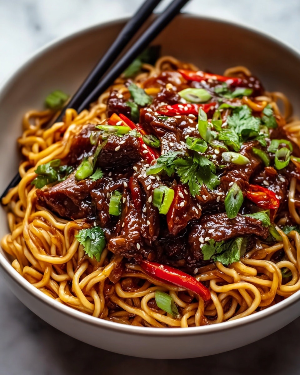A deep white bowl is filled with a base layer of glossy, tangled light brown noodles, coated in a rich sauce. On top, there are dark brown, shiny pieces of beef mixed with vibrant thin red chili peppers. Scattered over the beef and noodles are bright green chopped scallions and small leafy cilantro pieces. The dish is sprinkled with small white sesame seeds, adding texture and contrast to the rich colors. The bowl sits on a white marbled surface, with two black chopsticks resting inside the bowl at the back. photo taken with an iphone --ar 4:5 --v 7