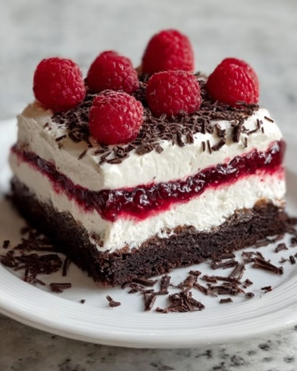 The image shows a square piece of cake with three clear layers. The bottom layer is dark brown and looks like chocolate cake. The middle layer is thin and white with a bit of red jam or fruit spread visible. The top layer is thick white cream topped with fresh red raspberries and small dark chocolate sprinkles. The cake is placed on a white plate, sitting on a white marbled surface. Photo taken with an iphone --ar 4:5 --v 7