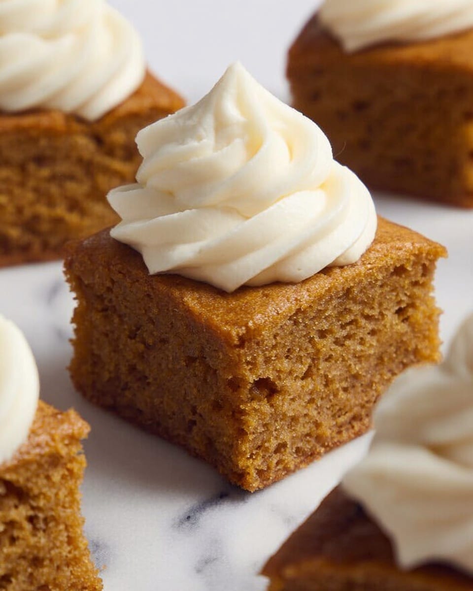 The image shows a close-up of square pieces of moist, brown cake arranged on a white marbled surface. Each cake square has a soft, dense texture with light crumbly edges. The center piece is topped with a thick swirl of smooth, white cream, which looks fluffy and rich, creating a nice contrast with the brown cake below. The swirl sits neatly on the top, adding height and an attractive shape to the dessert. Photo taken with an iphone --ar 4:5 --v 7