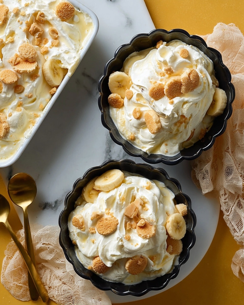 Two black bowls with scalloped edges are filled with a creamy dessert that has soft white whipped cream and light yellow custard mixed together. On top, there are small round golden brown cookie pieces scattered evenly. The texture appears soft and fluffy with visible swirls from the mixture. Next to the bowls is a white rectangular dish showing layers of banana slices, more of the creamy mixture, and cookie pieces. The setting is on a white marbled surface with a sheer beige cloth and two gold spoons placed nearby. Photo taken with an iphone --ar 4:5 --v 7