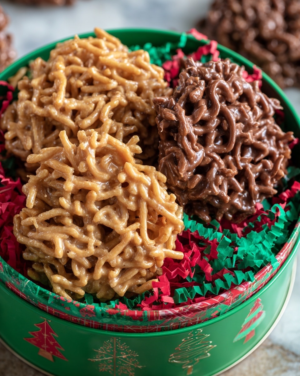 A round green gift tin decorated with Christmas designs holds two kinds of no-bake clusters. The clusters have one layer of crispy chow mein noodles coated in smooth, light tan peanut butter chocolate on the left side and another layer of the same noodles coated in darker milk chocolate on the right side. The clusters sit on a bed of red and green paper shreds inside the tin. The background is a white marbled texture. photo taken with an iphone --ar 4:5 --v 7