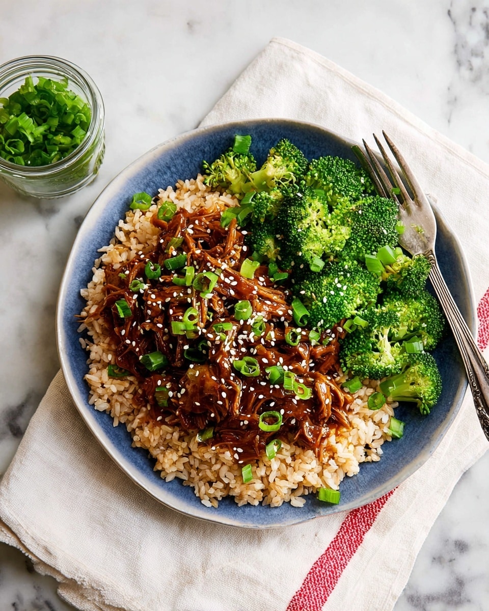 The image shows a black slow cooker filled with shredded, saucy, brownish-red cooked jackfruit layered with chopped fresh green onions scattered on top. A wooden spoon rests inside the cooker, partially turning the jackfruit mixture, revealing its tender texture and glossy sauce. The scene is set on a white marbled surface. photo taken with an iphone --ar 4:5 --v 7