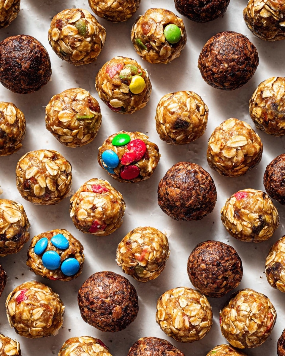 Multiple rows of small round energy balls are spread on a white marbled surface, arranged neatly in a grid pattern. The balls vary in color and texture with some showing a light golden oat base speckled with colorful candy pieces in purple, blue, green, and pink, while others have a darker chocolatey base with visible oat flakes. The balls have a glossy surface and rough texture from oats and mix-ins, showing subtle variations of light brown, dark brown, and creamy beige throughout. The image captures these bite-sized treats from above, showcasing their uniform size and vibrant mix of ingredients. photo taken with an iphone --ar 4:5 --v 7