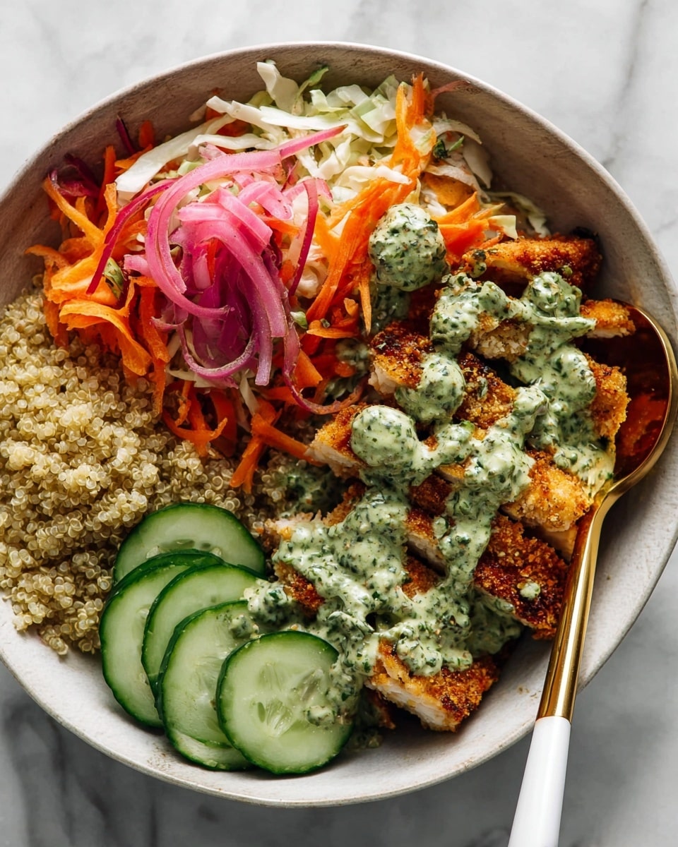 A white bowl with three main parts: on the bottom left, a layer of cooked quinoa with a light tan color; next to it on the lower right, several slices of fresh green cucumber arranged in a neat line; on the top right, crispy fried chicken pieces with a golden brown crust, covered with a creamy green herb sauce drizzled unevenly. Above the chicken, there is a colorful salad made of shredded white cabbage, orange carrot strips, and thinly sliced pickled red onions adding purple tones. A gold spoon with a white handle rests inside the bowl on the right side. The bowl sits on a white marbled surface. photo taken with an iphone --ar 4:5 --v 7