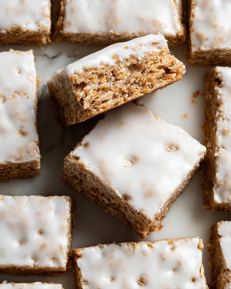 The image shows several square oat bars arranged close together on a white marbled surface, with one bar slightly tilted on top of another. Each bar has two clear layers: a bottom light brown and textured oat base, and a top layer of smooth, white icing that covers the whole surface unevenly, with small holes and bumps visible. The bars have rough edges, showing the crumbly texture inside, and the white icing contrasts softly with the brown oat base underneath. photo taken with an iphone --ar 4:5 --v 7